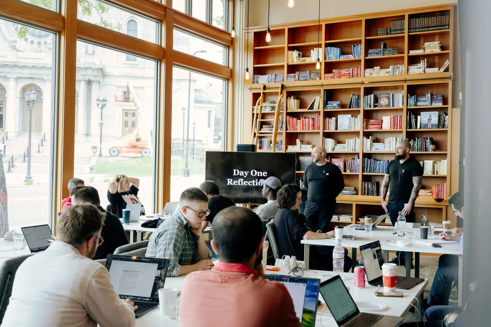 A packed workshop session in front of the library wall