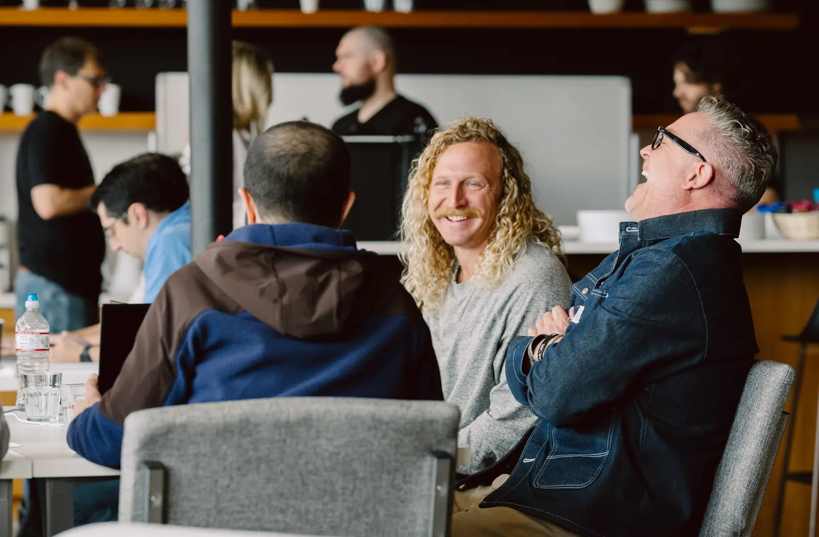 Attendees laughing during a breakout conversation