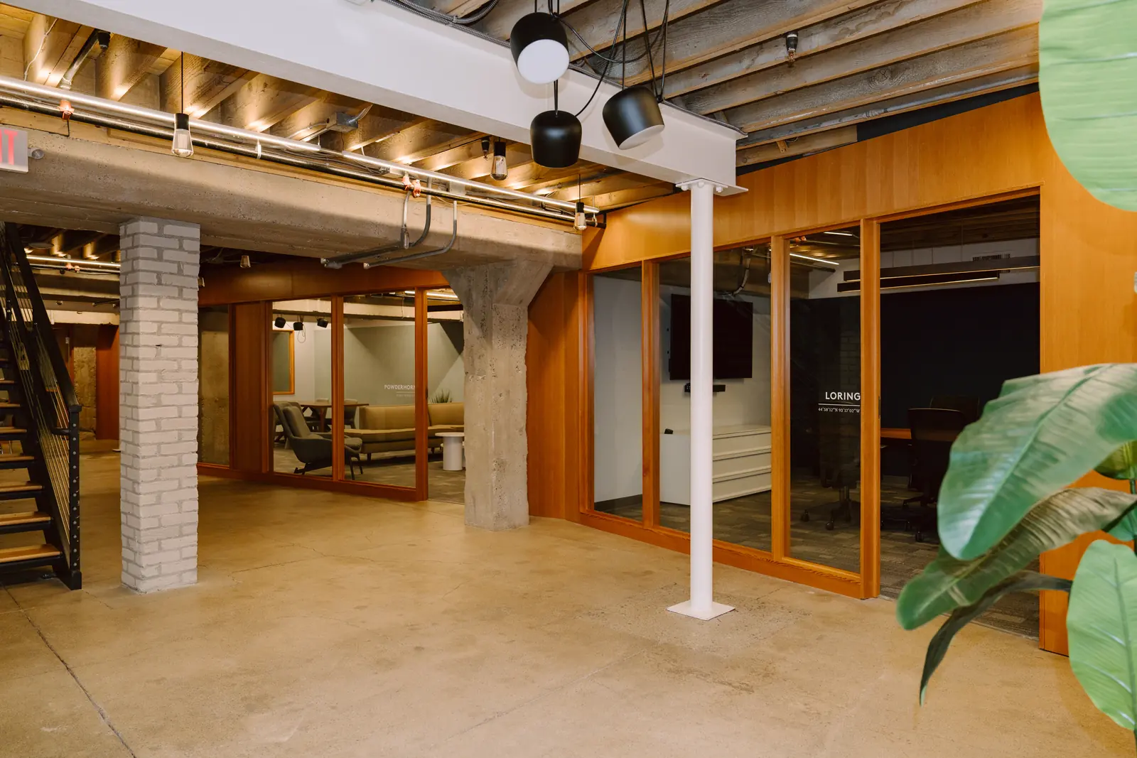 Lower level hallway with exposed beams and warm lighting