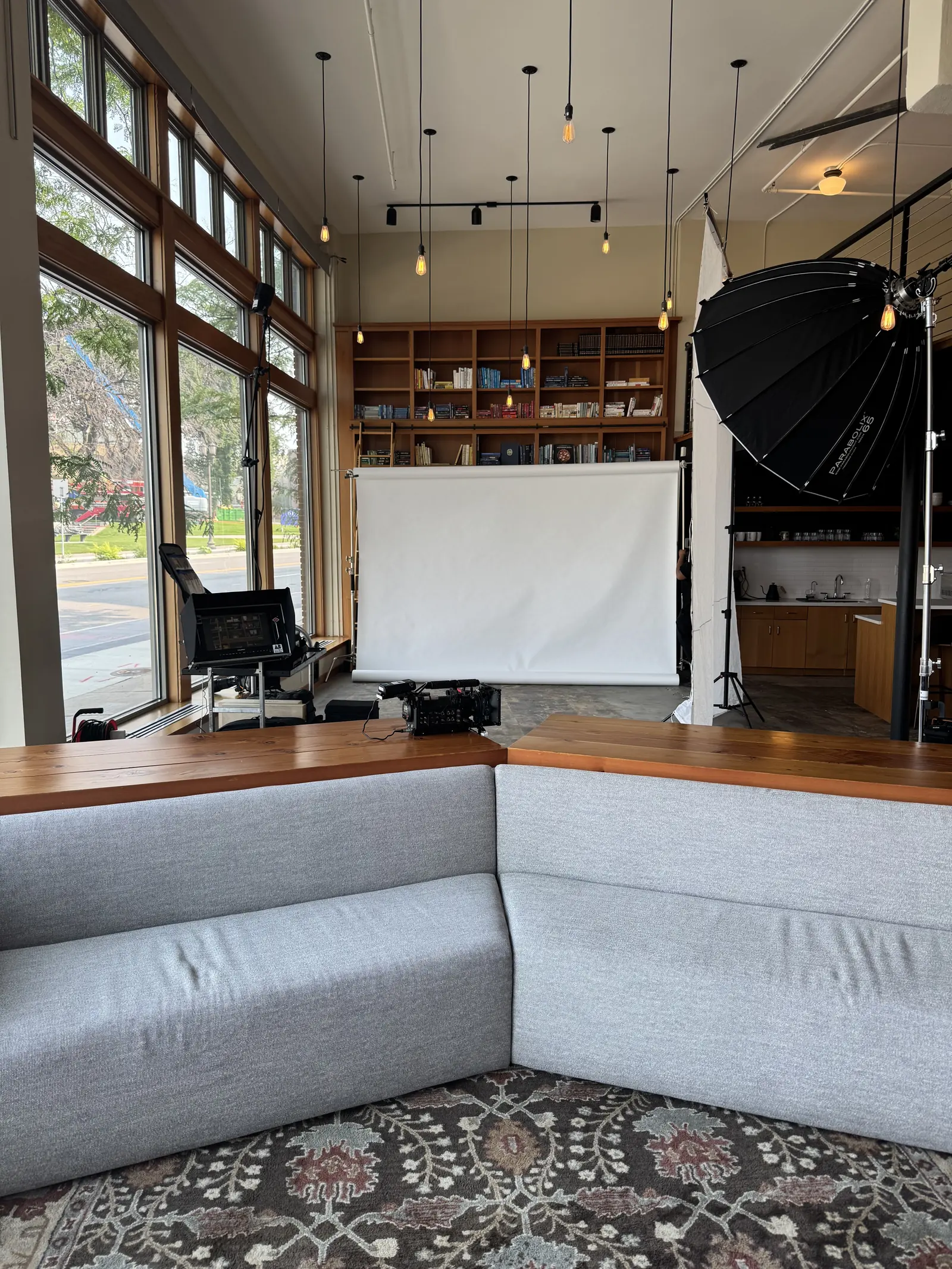 Photo shoot setup with a backdrop and softbox on the main floor