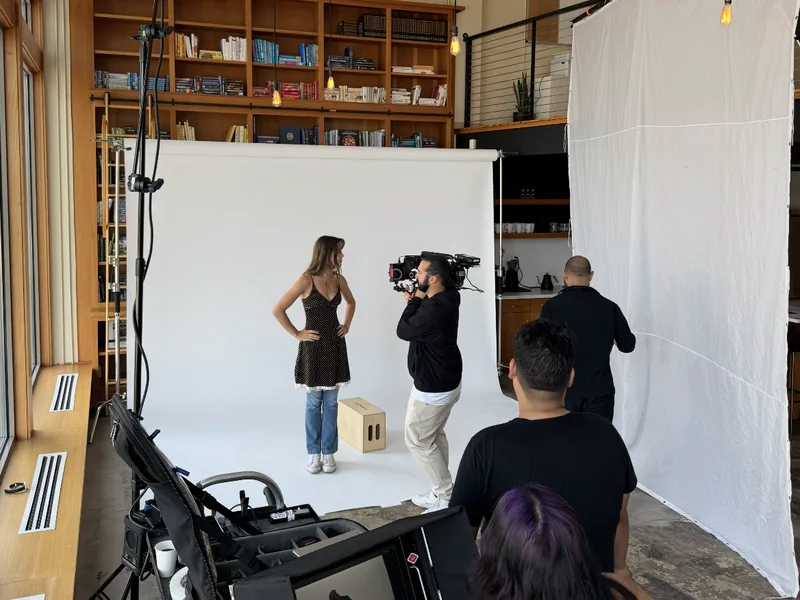Video shoot on a seamless backdrop in front of the library wall