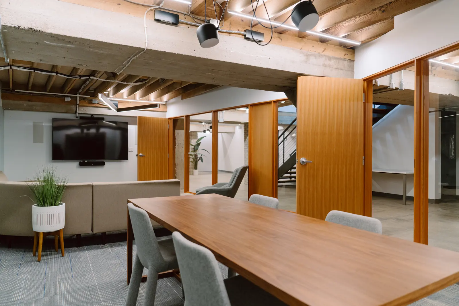 Conference room with long wooden table and screen