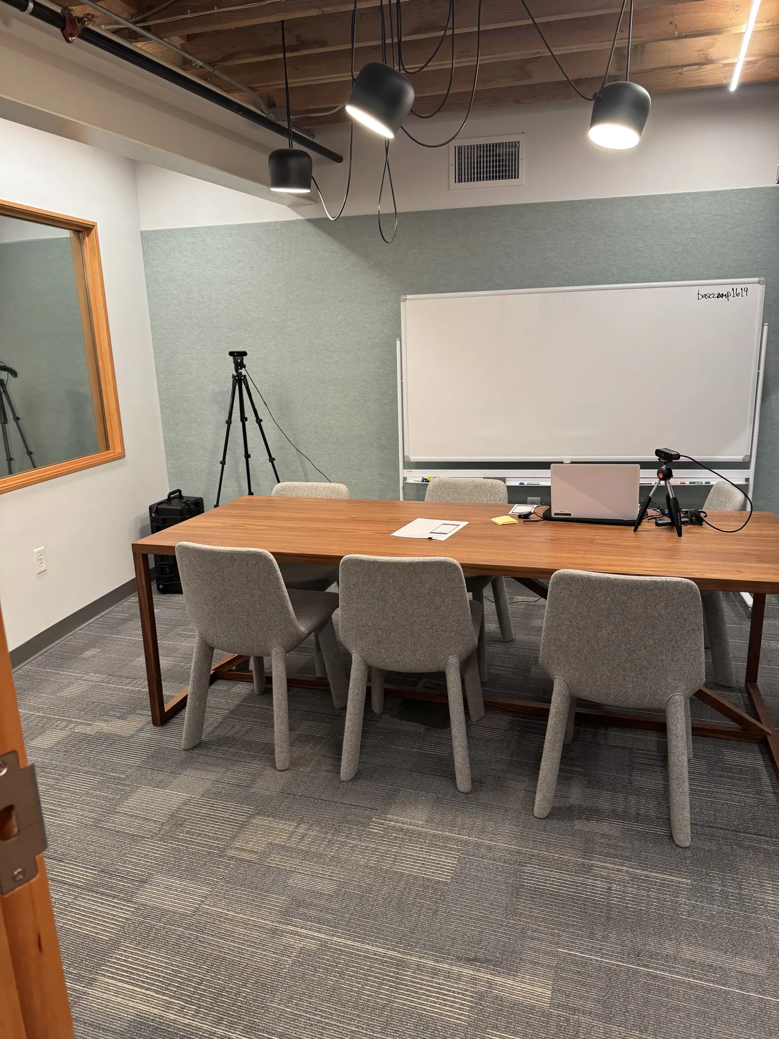 Lower-level conference room with whiteboard and camera setup